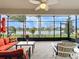 Enclosed patio boasting comfortable seating, ceiling fan, and scenic water view at 15434 Santa Pola Dr, Wimauma, FL 33598