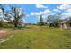 Sprawling backyard with a shed, mature trees, and a screened-in lanai attached to the house at 1731 Joe Mcintosh Rd, Plant City, FL 33565