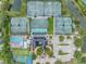 Beautiful aerial view of the community clubhouse, showcasing the multiple tennis courts, pool, basketball courts and more at 18823 Avenue Biarritz, Lutz, FL 33558