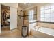 Bathroom features glass shower, soaking tub, granite counter, and decorative tile accents at 18823 Avenue Biarritz, Lutz, FL 33558