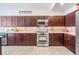 Modern kitchen features wood cabinets, stainless steel appliances, and bar seating at 18823 Avenue Biarritz, Lutz, FL 33558