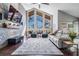 Living room featuring high ceilings, lots of natural light and brick accent wall with fireplace at 18823 Avenue Biarritz, Lutz, FL 33558