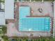 Aerial view of the community pool featuring lap lanes, a wading pool, and a seating area at 18823 Avenue Biarritz, Lutz, FL 33558