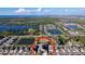 Aerial view of the home showcasing the spacious fenced backyard, patio, and pond in the neighborhood at 197 Rain Berry Ave, Ruskin, FL 33570