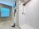 Bathroom features a tiled walk-in shower with a window for natural light at 197 Rain Berry Ave, Ruskin, FL 33570
