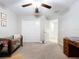 Bedroom with carpet, closet, a ceiling fan, and a door at 197 Rain Berry Ave, Ruskin, FL 33570