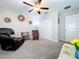 Spacious bedroom with a ceiling fan, leather recliner, and a comfortable rocking chair at 197 Rain Berry Ave, Ruskin, FL 33570