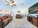 Comfortable living room featuring tile flooring, ceiling fan, and an open-concept design at 197 Rain Berry Ave, Ruskin, FL 33570