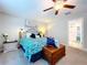 Comfortable bedroom with carpet floor, ceiling fan, and walk-in bathroom at 197 Rain Berry Ave, Ruskin, FL 33570