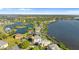An aerial panorama captures waterfront homes lining a beautiful lake and bay at 2077 N Pointe Alexis Dr, Tarpon Springs, FL 34689
