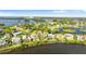 An aerial shot highlights waterfront homes with pools and access to a serene bay at 2077 N Pointe Alexis Dr, Tarpon Springs, FL 34689