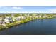 Aerial photo shows waterfront homes with lush landscaping, bay access, and serene lake views at 2077 N Pointe Alexis Dr, Tarpon Springs, FL 34689