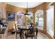 Charming dining area featuring a decorative table with wrought-iron chairs, natural lighting, and cozy decor details at 2077 N Pointe Alexis Dr, Tarpon Springs, FL 34689