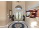 Grand foyer featuring a decorative rug, soaring ceilings and elegant double doors with decorative stained glass at 2077 N Pointe Alexis Dr, Tarpon Springs, FL 34689