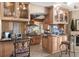 Spacious kitchen with granite counters, custom cabinetry, stainless appliances, and eat-in counter space for casual dining at 2077 N Pointe Alexis Dr, Tarpon Springs, FL 34689