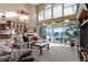 Bright living room boasts high ceilings, fireplace, and sliding glass doors leading to the outdoor deck at 2077 N Pointe Alexis Dr, Tarpon Springs, FL 34689