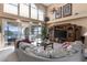 Spacious living room with water views, large windows, comfortable seating, and built-in entertainment center at 2077 N Pointe Alexis Dr, Tarpon Springs, FL 34689