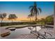 Inviting backyard pool featuring a unique design and relaxing lounge chairs with scenic ocean views at 2077 N Pointe Alexis Dr, Tarpon Springs, FL 34689