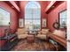 Comfortable sitting room with a large window, two chairs, and a small table at 2077 N Pointe Alexis Dr, Tarpon Springs, FL 34689