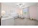 Calm Bedroom featuring a white crib, rocking chair, soft carpet, and pink accents creating a peaceful and inviting space at 21181 Threadfin Way, Land O Lakes, FL 34638