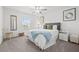 Comfortable bedroom with a bed, carpet, natural light, and simple nautical decor at 21181 Threadfin Way, Land O Lakes, FL 34638