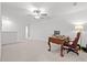 Spacious bonus room with neutral carpet, ceiling fan, desk, and decorative chair at 21181 Threadfin Way, Land O Lakes, FL 34638