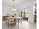 Bright dining room with elegant chandelier, stylish table, and sliding doors to a screened lanai at 21181 Threadfin Way, Land O Lakes, FL 34638