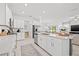 Bright, open kitchen with island, stainless appliances, and adjacent living area at 21181 Threadfin Way, Land O Lakes, FL 34638