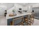 Modern kitchen island with white countertop, stainless steel appliances and breakfast bar seating at 21181 Threadfin Way, Land O Lakes, FL 34638