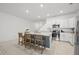 Modern kitchen with stainless steel appliances, white cabinets, and a spacious island with seating at 21181 Threadfin Way, Land O Lakes, FL 34638
