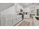 White kitchen cabinets and countertops with stainless steel appliances at 21181 Threadfin Way, Land O Lakes, FL 34638