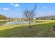 Scenic view of a tranquil pond reflecting nearby buildings, creating a serene and picturesque landscape at 21181 Threadfin Way, Land O Lakes, FL 34638