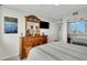 Spacious main bedroom showcasing a wooden dresser with decorative mirror and access to closet at 223 Island Way # 7H, Clearwater, FL 33767