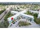Aerial view of a condominium building, with parking and surrounding foliage at 2370 Jamaican St # 30, Clearwater, FL 33763