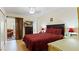 Cozy bedroom featuring warm wood floors, a television, and access to an outdoor patio at 2370 Jamaican St # 30, Clearwater, FL 33763