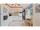 A practical kitchen with white cabinets and a breakfast nook area at 2370 Jamaican St # 30, Clearwater, FL 33763