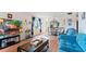 A comfortable living room with a large television and a view into the dining area at 2370 Jamaican St # 30, Clearwater, FL 33763