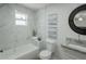 Modern bathroom featuring a bathtub with marble-look tile and a stylish vanity with a granite countertop at 2650 22Nd S Ave, St Petersburg, FL 33712