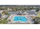 Aerial view of the community pool, clubhouse, and surrounding landscape at 29500 Blackwolf Run Loop, San Antonio, FL 33576