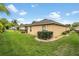 Well-manicured backyard featuring lush green grass and mature landscaping at 29500 Blackwolf Run Loop, San Antonio, FL 33576