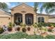 Charming home featuring mature landscaping including unique lawn ornaments at 29500 Blackwolf Run Loop, San Antonio, FL 33576