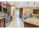 Modern kitchen with stainless steel appliances, granite countertops, and dark wood cabinetry at 29500 Blackwolf Run Loop, San Antonio, FL 33576