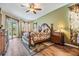 Serene main bedroom featuring wood floors, a ceiling fan, and access to the outdoor area at 29500 Blackwolf Run Loop, San Antonio, FL 33576