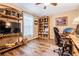 Home office with hardwood flooring, a ceiling fan, large window, and nice built in bookshelves at 29500 Blackwolf Run Loop, San Antonio, FL 33576