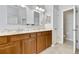 Bathroom vanity features double sinks, wood cabinets, granite countertop, and tiled flooring at 3510 Brook Crossing Dr, Brandon, FL 33511