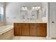 Bathroom boasts double sinks, wood cabinets, granite countertop, and tiled flooring at 3510 Brook Crossing Dr, Brandon, FL 33511