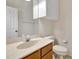 Half bathroom featuring a wood vanity, marble sink, and overhead cabinetry, with a toilet at 3510 Brook Crossing Dr, Brandon, FL 33511