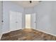 Bedroom with wood-look floors, ceiling fan and a double door closet at 3510 Brook Crossing Dr, Brandon, FL 33511