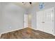 Bedroom with wood-look floors, ceiling fan, decal, and a double door closet at 3510 Brook Crossing Dr, Brandon, FL 33511