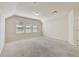 Spacious bonus room with neutral carpet, three windows, and ample natural light at 3510 Brook Crossing Dr, Brandon, FL 33511
